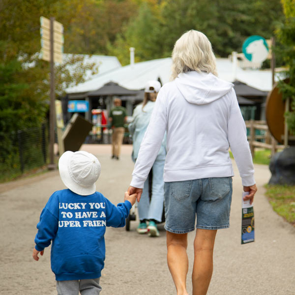 Woman and Child holding hands walking at the Zoo