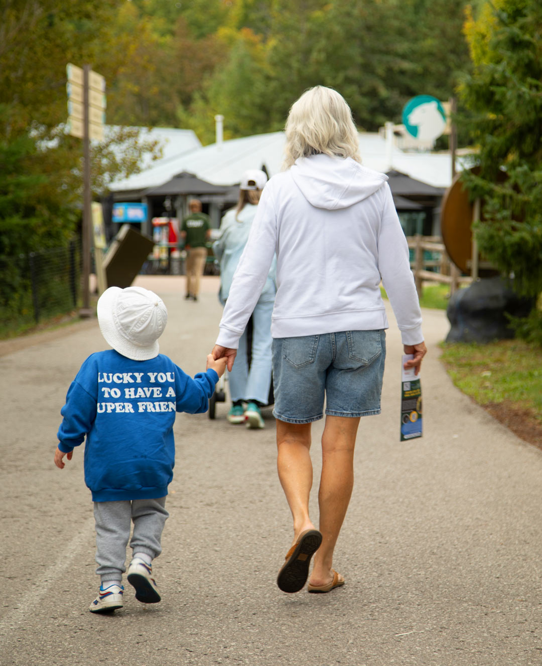 Woman and Child holding hands walking at the Zoo