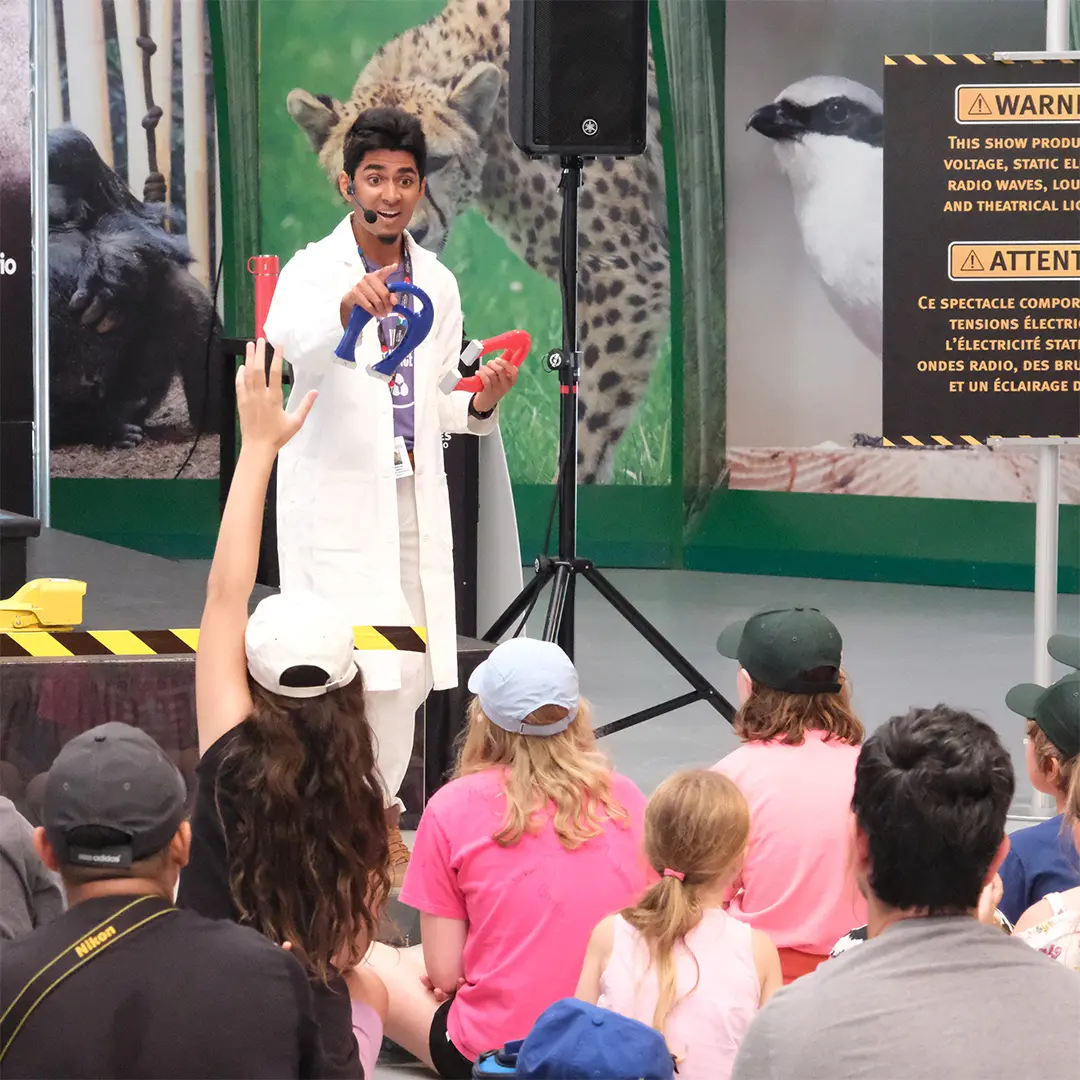 Representative from the Ontario Science Centre engages an audience at the Toronto Zoo