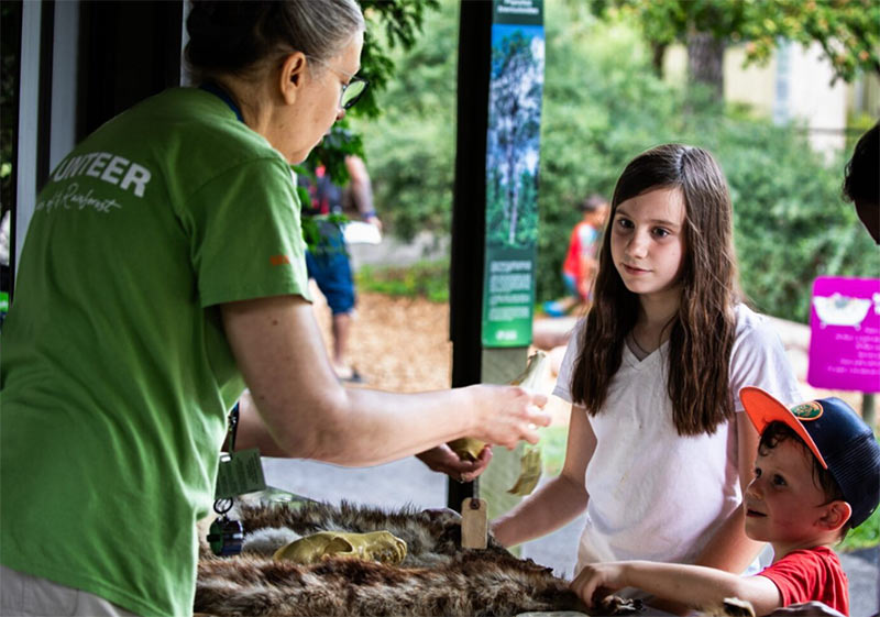 Volunteer helping two kids